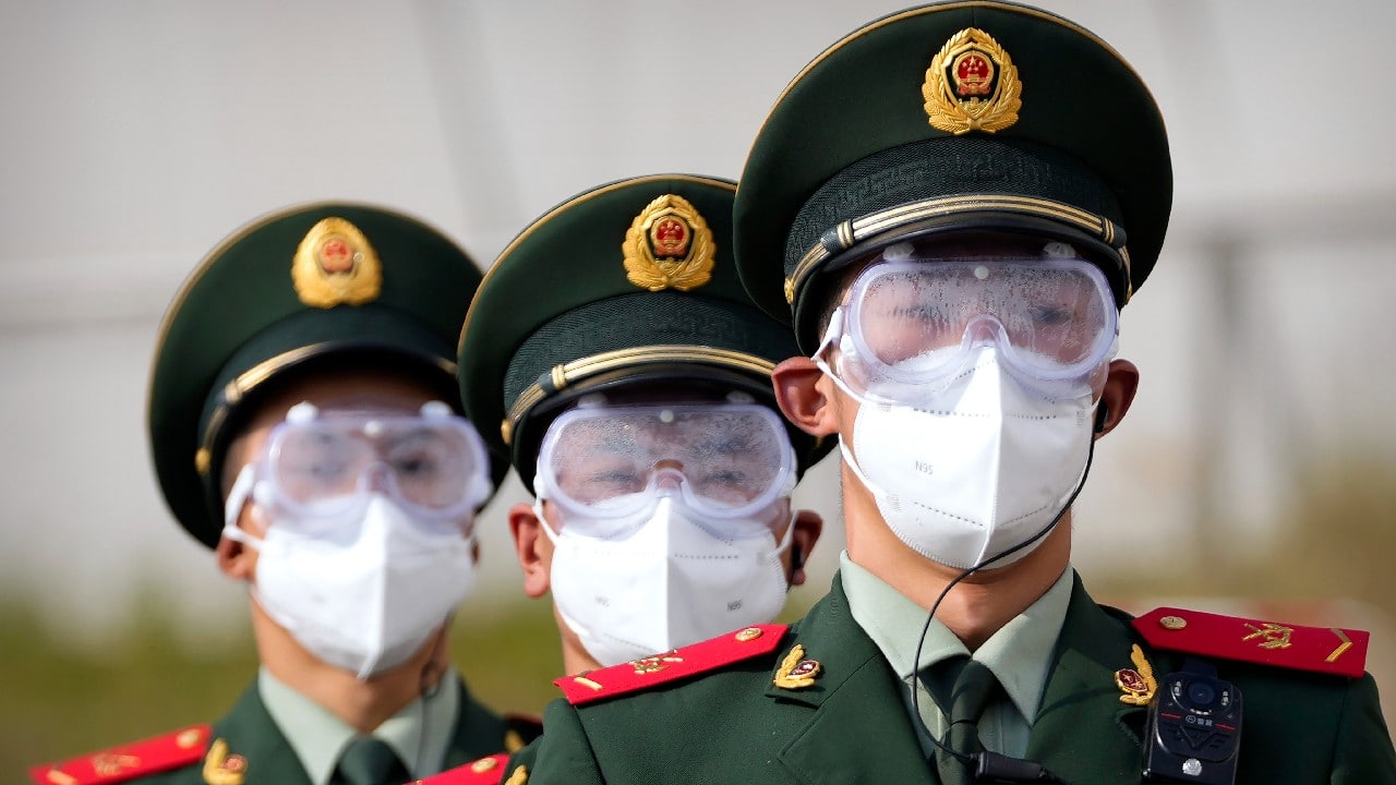 Chinese paramilitary police wearing goggles and face masks march in formation at the Yanqing National Sliding Center during an IBSF sanctioned race, a test event for the 2022 Winter Olympics, in Beijing, October 25. A northwestern Chinese province heavily dependent on tourism closed all tourist sites Monday after finding new COVID-19 cases. The spread of the delta variant by travellers and tour groups is of particular concern ahead of the Winter Olympics in Beijing in February. Overseas spectators already are banned, and participants will have to stay in a bubble separating them from people outside. (Image: AP)