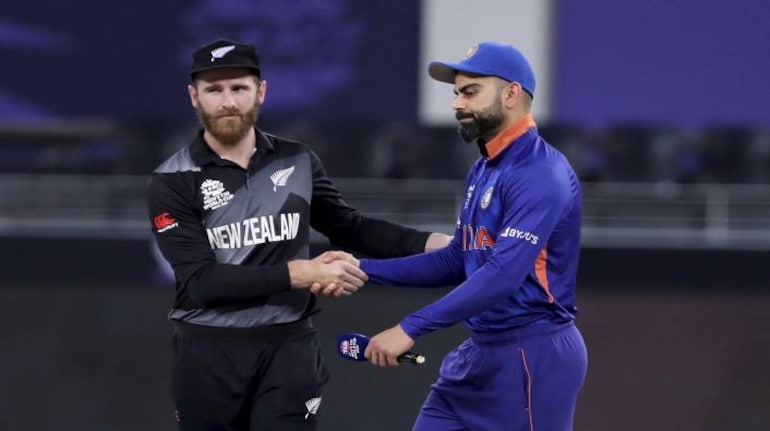 India's captain Virat Kohli, right, reacts as he shakes hands with New Zealand's captain Kane Williamson after losing the toss ahead of the Cricket Twenty20 World Cup match between New Zealand and India in Dubai, UAE, Sunday, Oct. 31, 2021. (AP Photo/Aijaz Rahi)