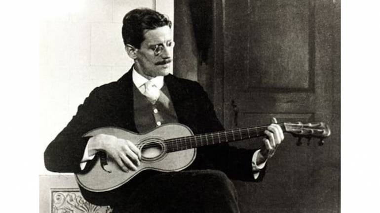 James Joyce Playing A Guitar In 1915. (Source: Cornell Joyce Collection Via Wikimedia Commons)
