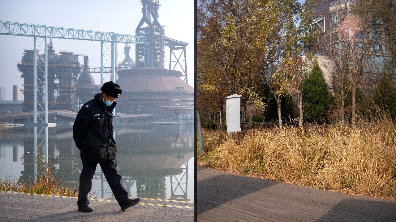 A security guard walks past a mirror at a sculpture installation, which is reflecting a nearby green space, at a public park converted from a former industrial area, on a day with high levels of air pollution in Beijing, November 18. (Image: AP/Mark Schiefelbein)