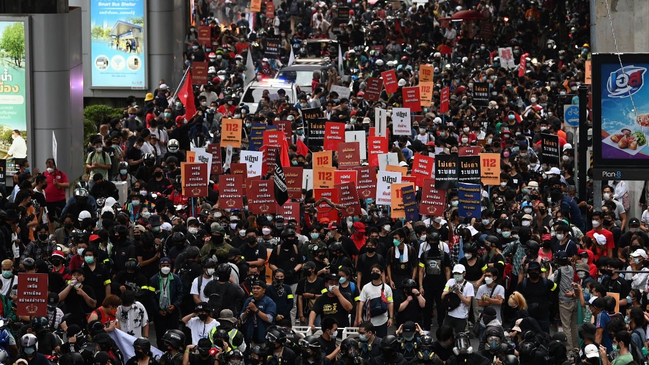 Anti-government protesters hold banners calling for the monarchy reform marching to the German embassy in Bangkok, Thailand, November 14. Protesters calling for the reform of the monarchy returned to the streets of Bangkok despite the ruling of the Constitutional Court on Wednesday that such demands are tantamount to attempting to overthrow the system of government with the king as head of state. (Image: AP/Surat Sappakun)