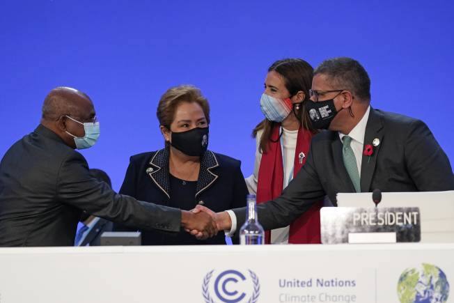 Alok Sharma, right, President of the COP26 summit shakes hands with UNGA President Abdulla Shahid as outgoing COP president Carolina Schmidt, second right, and Patricia Espinosa, UNFCCC Executive-Secretary look on during the Procedural Opening of the COP26 U.N. Climate Summit in Glasgow, Scotland, Sunday, Oct. 31, 2021. The U.N. climate summit in Glasgow formally opens Sunday, a day before leaders from around the world gather in Scotland's biggest city to lay out their vision for addressing the common challenge of global warming. (AP Photo/Alberto Pezzali, Pool)