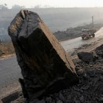 Trucks move along a road in the Mahanadi coal fields near Talcher town of Orissa . (PC-Reuters)
