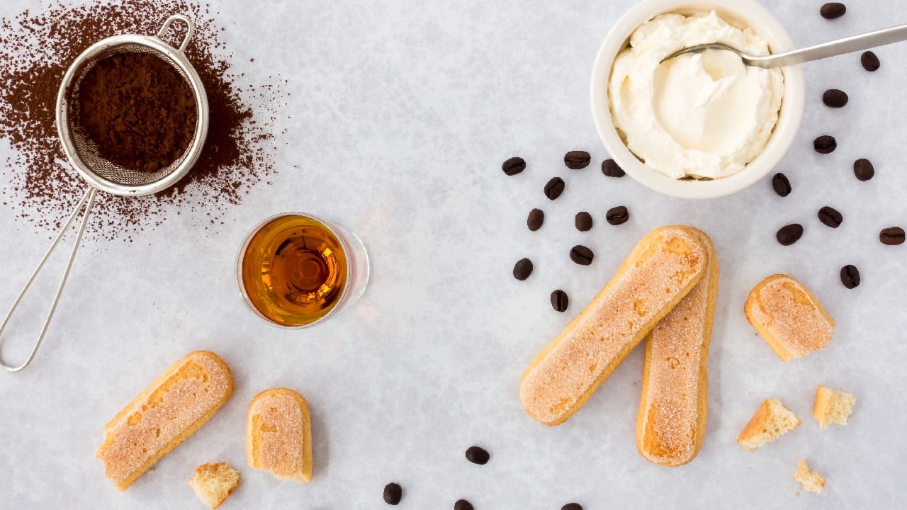 Tiramisu, literally translated as “pick me up”, is made of ladyfingers biscuits, also known as sponge fingers, dipped in coffee. The sponge cookies layered with the airy cream made by whipping together egg yolks, sugar and mascarpone cheese and sprinkled with cocoa. (Image: Shutterstock)