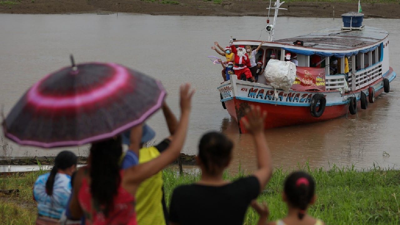 Furthermore, he lets AFP know, there's nothing really jolly about having to wear the heavy plush outfit in the sweltering Amazon heat, and bringing presents to kids in the most remote regions is no cakewalk. (Image: AFP)