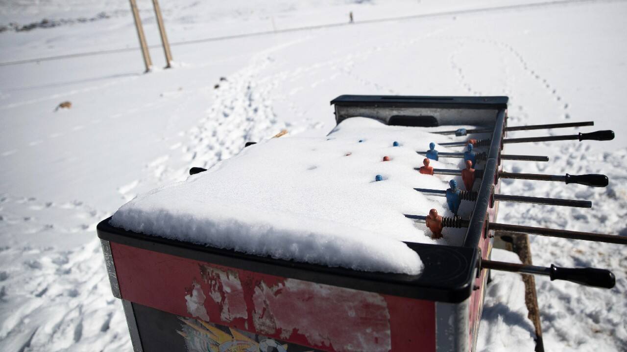 After just a week under the season's first snowfall, the pool and foosball tables that youths pass the time with are fully covered. The sheep are tucked together in a small barn for days. (Image: AP)