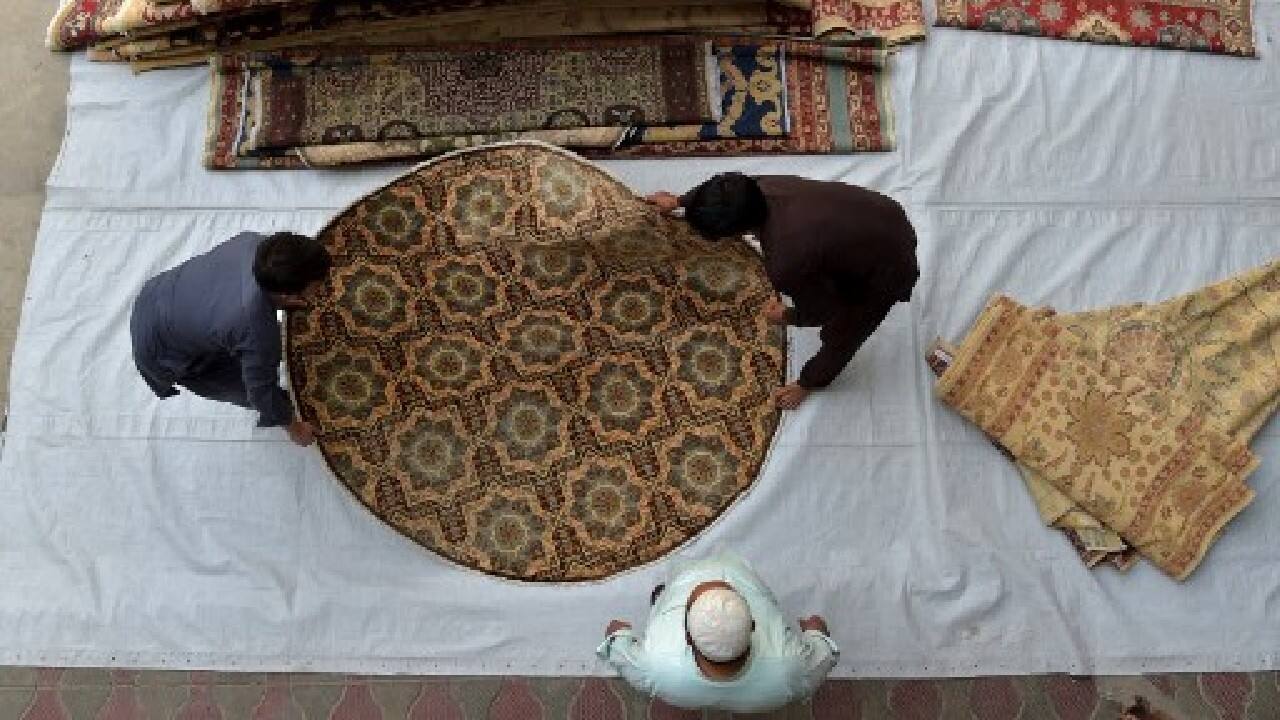 Now they pick strands from dangling spindles of silk before looping them into the warp and weft of the rug with precise, rhythmic energy. And when the 12-metre (39-foot) carpet is complete, they hope it will fetch up to $6,000 dollars (5,300 euros). (Image: AFP)