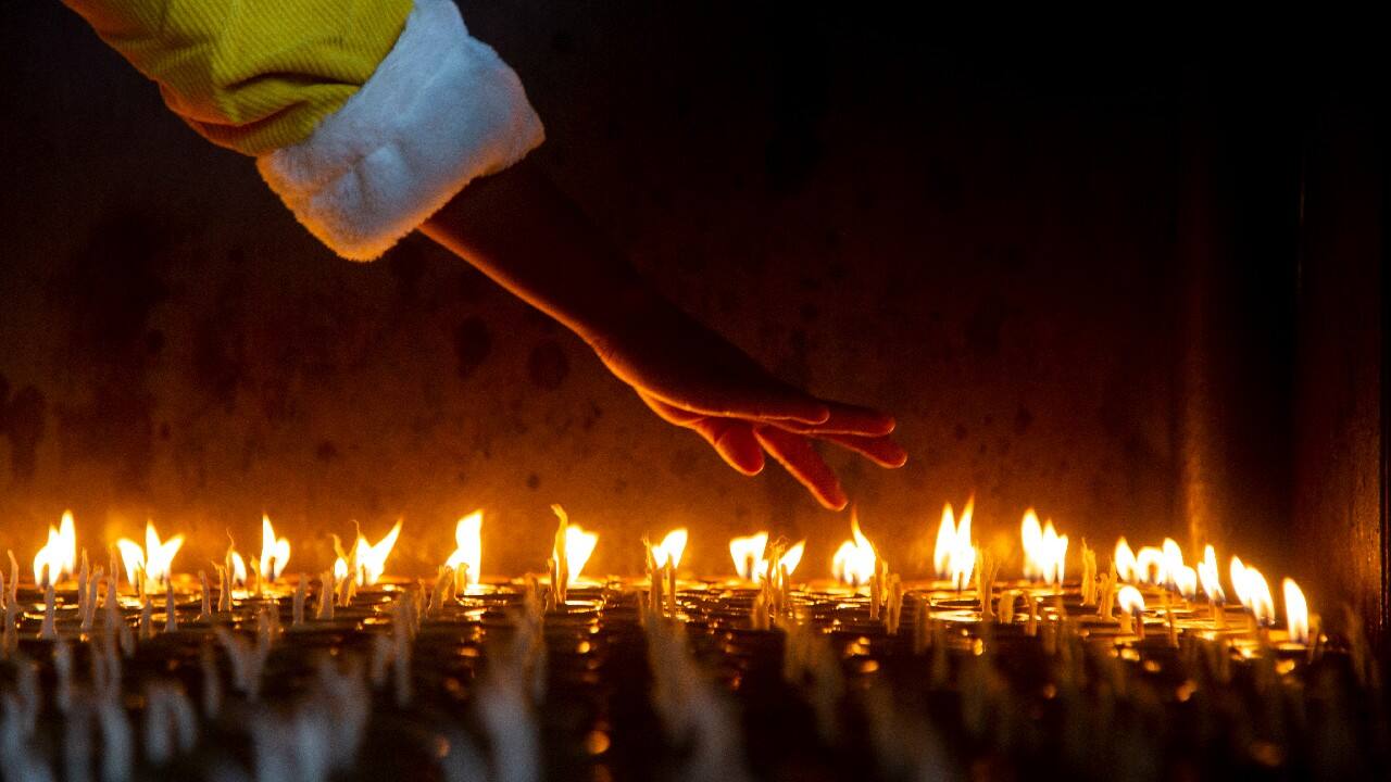 A Nepalese devotee counts butter lamps before she lights them at the Boudhanath Stupa in Kathmandu, Nepal, December 27. Every day devotees light lamps at this iconic Buddhist monument which is also a major tourist attraction. (Image: AP)