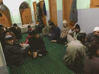 People seated inside a hamam built into a mosque. (Photo credit: Firdous Hassan)