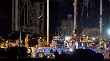 First responders work outside an Amazon fulfillment center after it was heavily damaged when a strong thunderstorm moved through the area Friday, Dec. 10, 2021, in Edwardsville, Ill. (AP Photo/Jeff Roberson)First responders work outside an Amazon fulfillment center after it was heavily damaged when a strong thunderstorm moved through the area Friday, Dec. 10, 2021, in Edwardsville, Ill. (AP Photo/Jeff Roberson)