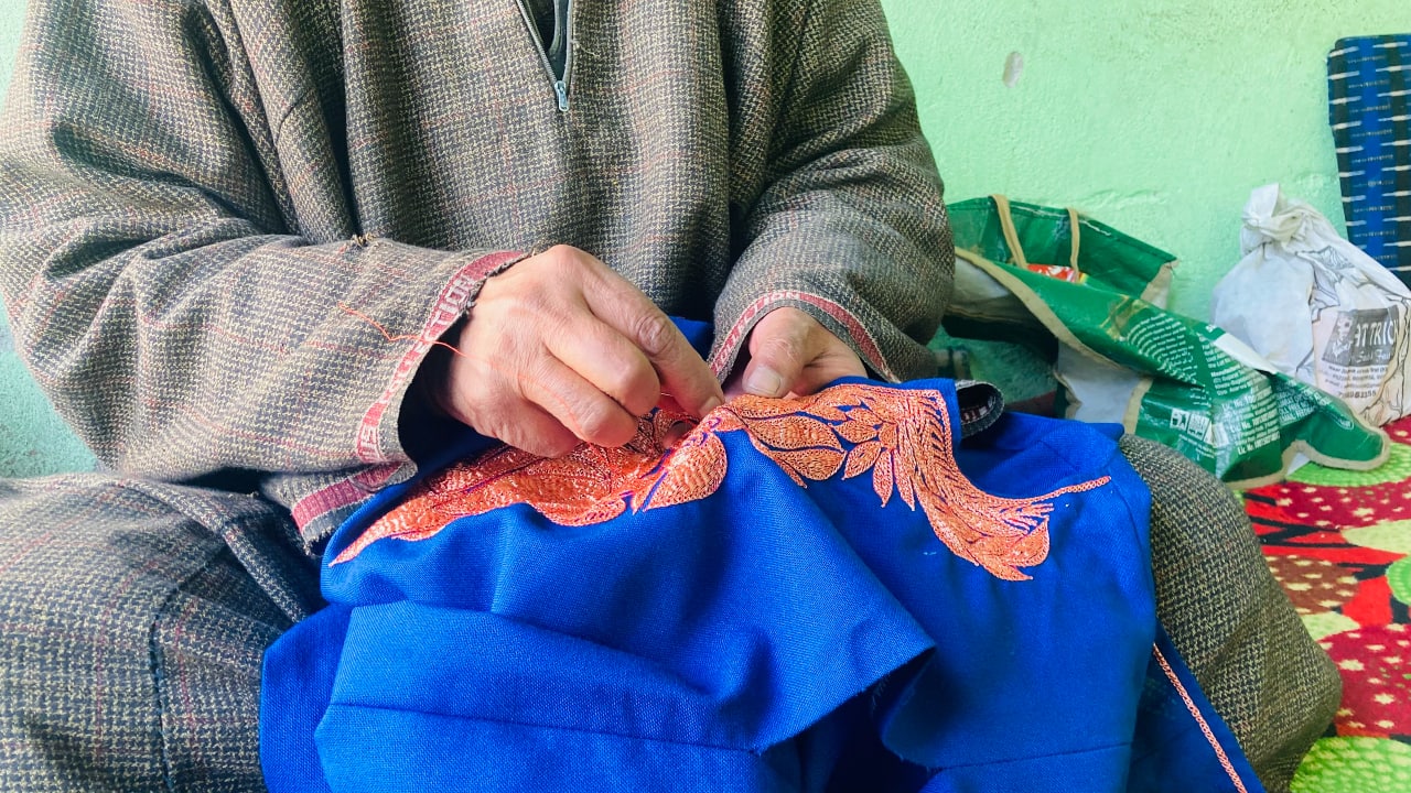 Embroidery is done with Tilla, which is a silver or golden coated thread. The popular Quraab Pherans (pherans with slits at the elbow, to pin up the lower half of the sleeve to the shoulder) has a stamp of Kashmir on the bosom – a Chinar leaf embroidered in Tilla. With the passage of time, pheran embroidery also evolved. It used to be tilla work and arikaam with simpler designs at first. Gradually, Bihari tilla, glass work, thread work and mukhta work were added. Now pherans sport a range of Kashmiri embroidery styles, from sozni to aari and tilla, either hand or machine made. (Photo by Irfan Amin Malik)