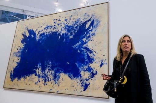 Curator of the exhibition "Le ciel comme atelier. Yves Klein et ses contemporains" and director of Palais de Tokyo Emma Lavigne poses beside "Anthropophagie bleue, Hommage à Tennesse Williams" (1960) by French artist Yves Klein at the Pompidou-Metz museum in Metz, eastern France on July 16, 2020.