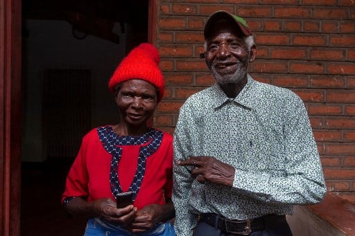 Malawian musician Giddes Chalamanda (R), 92, poses with his wife Margalita Alfred (L), 71, at their home in the Madzuwa Village near Chiradzulu, southern Malawi, on January 13, 2022. - At 92, Giddes Chalamanda has no idea what TikTok is. He doesn't even own a smartphone. And yet the Malawian music legend has become a social media star, with his hit song "Linny Hoo" garnering over 80 million views on the video-sharing platform and spawning mashups and remixes from South Africa to the Philippines.