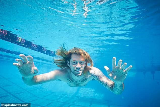 The former baby re-enacted the photo for money 'many times,' the lawyers said, even had the album title tattooed across his chest, appeared on a talk show wearing a self-parodying nude-colored onesie. (Image credit: Splash News)