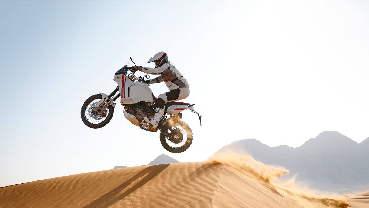The Desert X, once again, caters to a growing need for adventure-tourer bikes which are clearly more suited to India’s ever-altering terrain and battered road-works than hardcore sportsbikes. With a decidedly retro, twin round headlamp fairing and a 21-inch front wheel, the Desert X will tap into the popular retro design trend along with rider preference for off-road capable machines. The DesertX, gets long-travel suspension and a 937cc Testastretta V-twin engine (found in the Multistrada V2 and Monster models) with special off-road tyres, spoke wheels and a 874mm seat height, the DesertX is the most off-road capable Ducati in existence. 