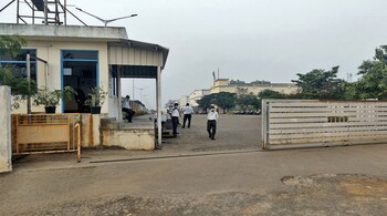 File image: Private security guards stand at the entrance of a closed plant of Foxconn India, which makes iPhones for Apple Inc, near Chennai, India, 