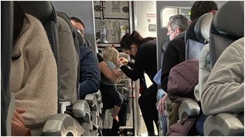 American Airlines' flight attendants try to keep Todd Lagerberg's 17-month-old son entertained during the 3.5 hour flight. (Image credit: LinkedIn)