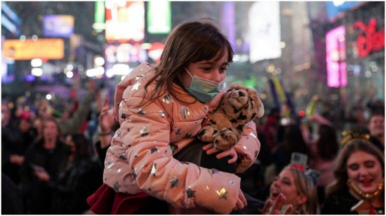 A child attends the New Year's celebrations in Times Square, as the Omicron coronavirus variant continues to spread, in the Manhattan borough of New York City, U.S., January 1, 2022. REUTERS/Dieu-Nalio Chery , Omicron accounts for 95% of new US cases: CDC, The World Live Breaking News Coverage & Updates IN ENGLISH