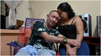 Victor Escobar, 60, a multi-disease patient awaiting euthanasia, hug his wife Diana during a meeting with his family to announce the date for his euthanasia procedure.