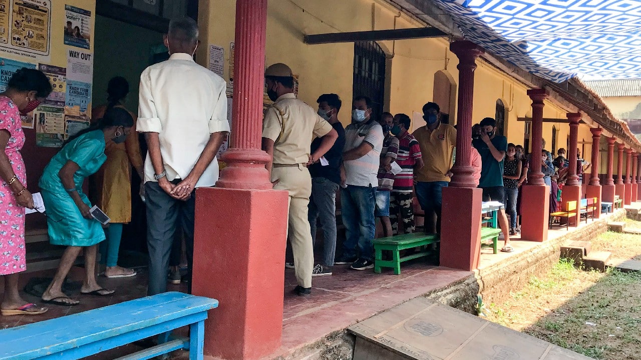 People line up to vote for the Goa state assembly elections in North Goa, February 14. Goa is one of the five states voting in phases in February and March in what is seen as a test for Prime Minister Narendra Modi's Bhartiya Janata Party ahead of general elections expected in 2024. (Image: AP)
