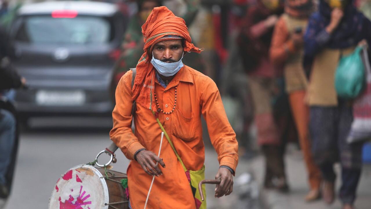 Most people in India say they wear masks to avoid paying fines. And, consequently, masks loll on chins, hang below the nose and sometimes rest atop heads like eyeglasses. (Image: AP)
