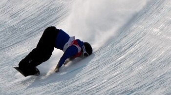 Italy's Louis Phillip Vito III falls as he competes during the men's halfpipe qualification round at the 2022 Winter Olympics, February 9, in Zhangjiakou, China. (Image: AP)