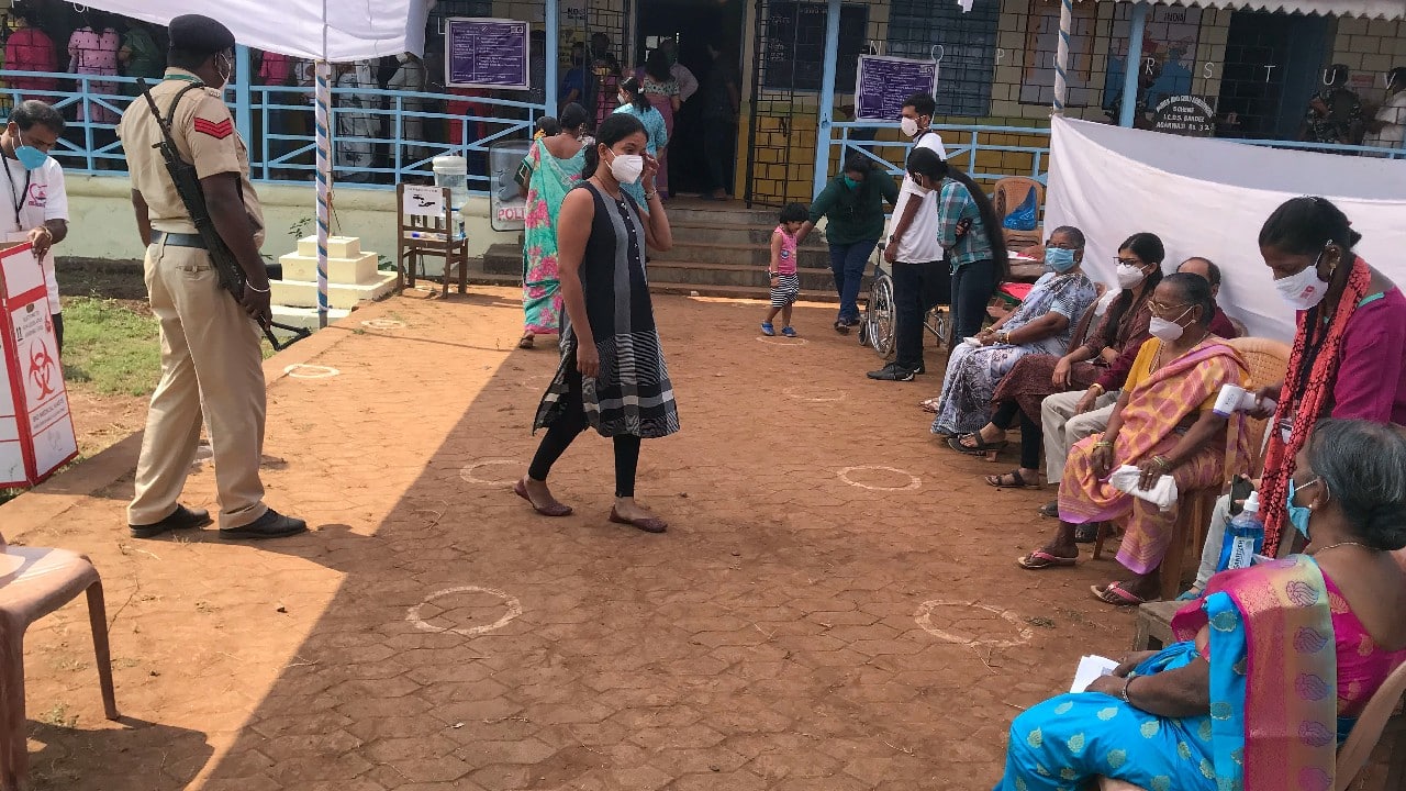 In Goa, Voting is underway across all 40 seats today while following COVID-19 protocol. As many as 301 candidates are contesting from 40 seats of Goa. Markings are made on the floor to ensure social distancing as people wait to vote for the Goa state assembly elections in North Goa, February14. (Image: AP)