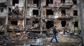 A man walks past a building damaged following a rocket attack the city of Kyiv, Ukraine, February 25. (Image: AP Photo/Emilio Morenatti)