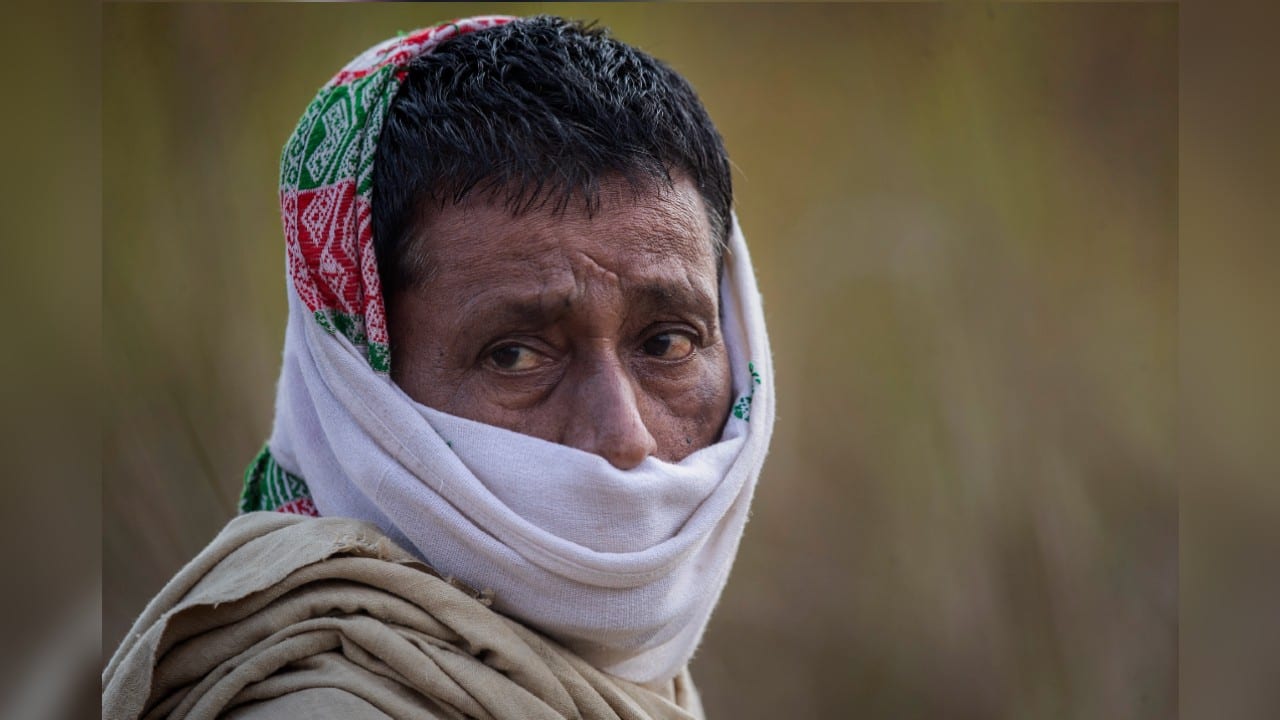 Atul Teron said he can’t buy a mask in his village and that he’d rather tie a scarf around his face. “My traditional scarf gives more protection than the other masks,” he said. (Image: AP)