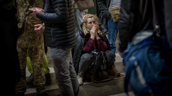 A woman reacts as she waits for a train trying to leave Kyiv, Ukraine. (Image: AP)
