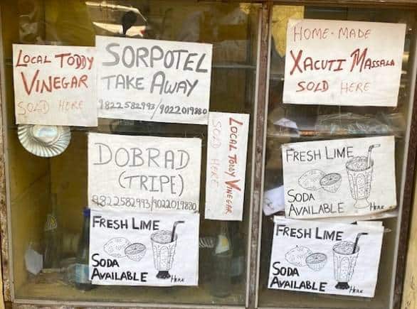 For the menu in English, turn to the A4 size printouts pasted on the glass panes: Sorpotel takeaway. Xacuti masala. Local toddy vinegar. Dobrad (tripe)...