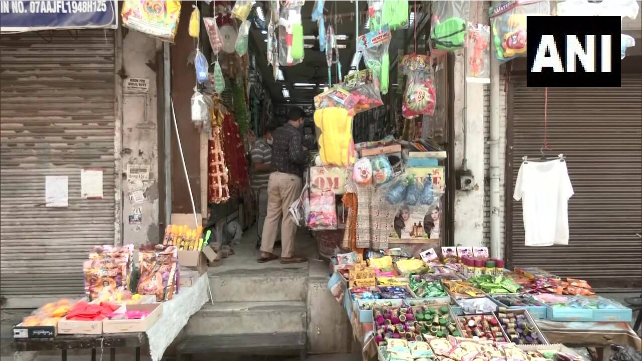 Preparations begin for the celebration of the two-day festival of Holi in Laxmi Nagar market in Delhi as people throng the shops for festivities-related shopping. (Image: Twitter @ANI)