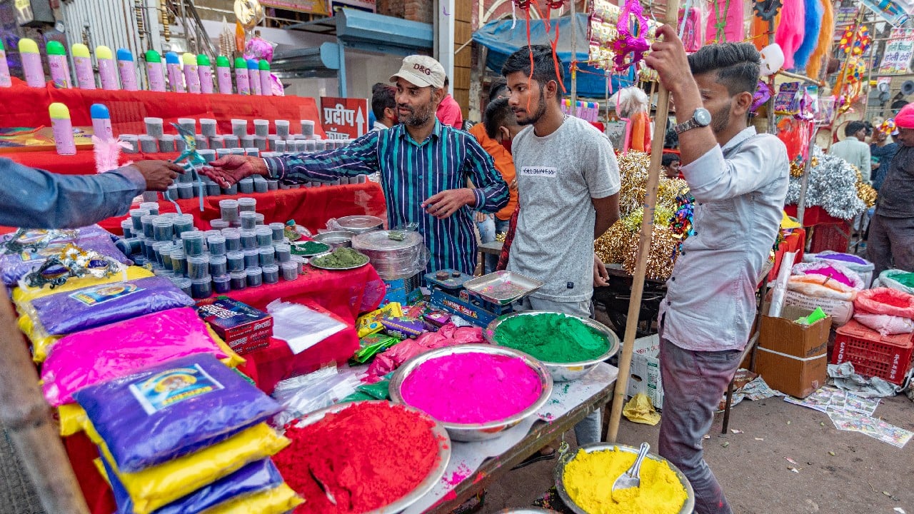 A vendor sells colored powder on the eve of Holi, the festival of colors in Prayagraj, Uttar Pradesh, March 17. (Image: AP)