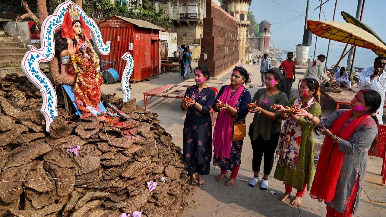 Women pray during 'Holika Dahan' on the eve of Holi, the Festival of Colours, in Varanasi, March 17. (Image: PTI)
