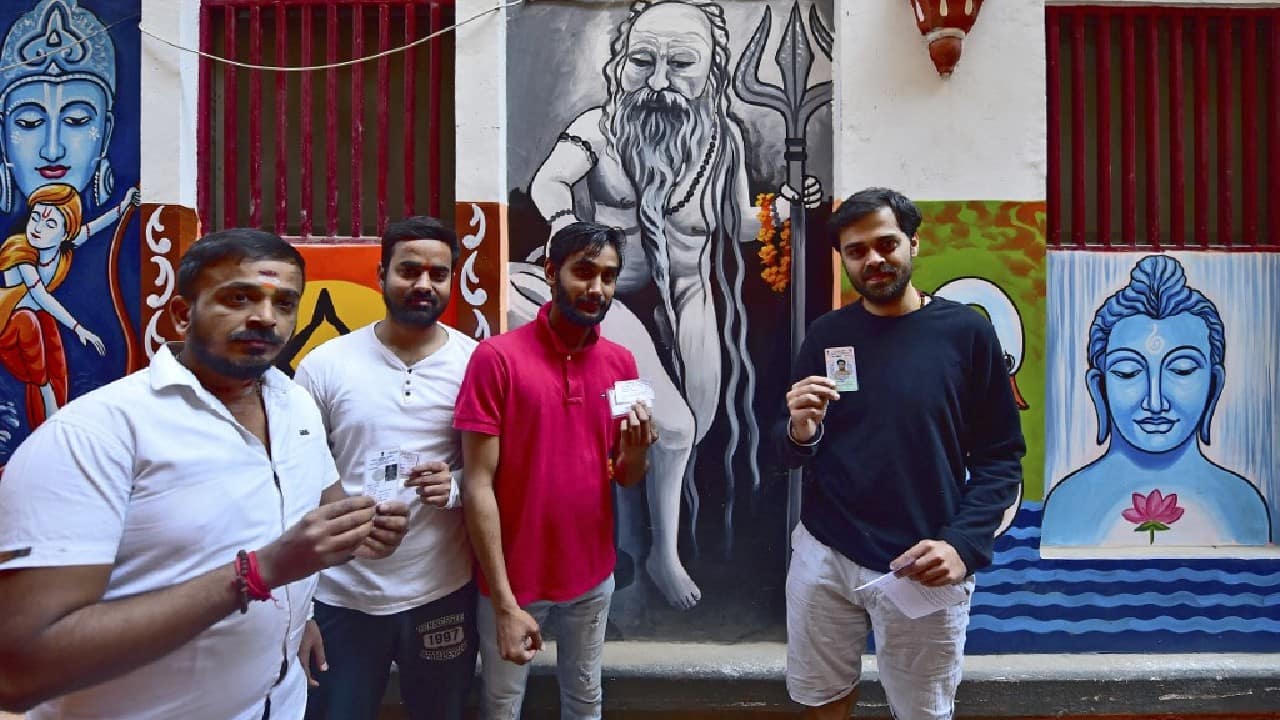 Voters pose as they arrive at a polling station to cast their ballot during the final phase of the Uttar Pradesh state assembly elections, in Varanasi on March 7. (Image: AFP)