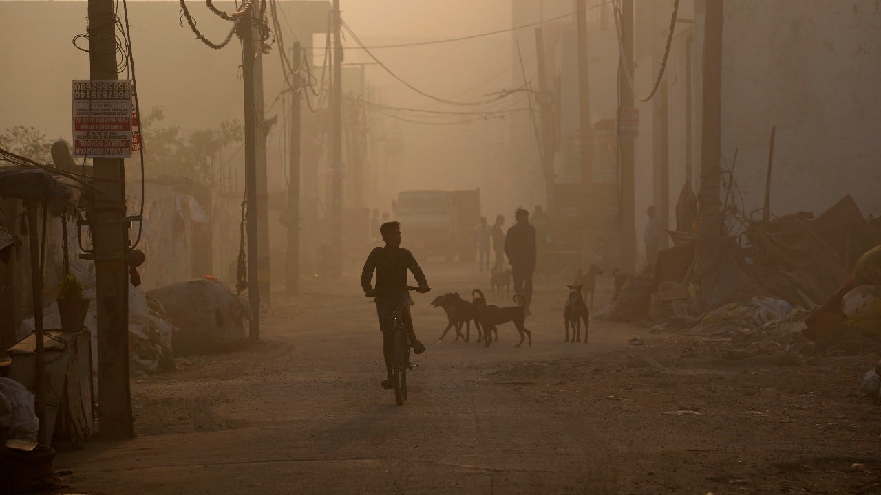 Acrid smoke hung over the capital city after a massive landfill caught fire during a scorching heat wave, forcing informal waste workers to endure hazardous conditions. (Image: AP)