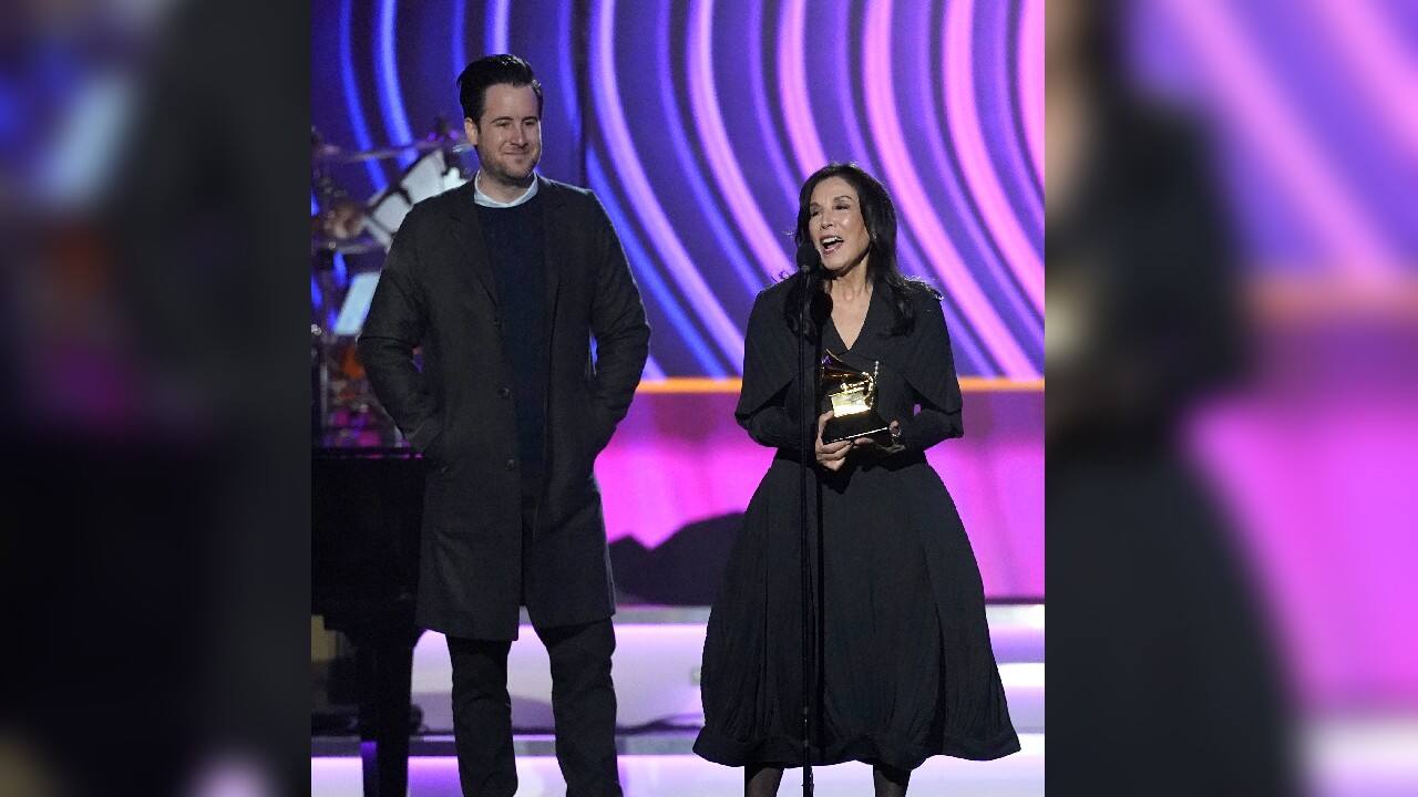 David Zonshine, left, and Olivia Harrison accept the award for best boxed or special limited edition package for &quot;All Things Must Pass: 50th Anniversary Edition&quot; at the 64th Annual Grammy Awards. (Image: AP)