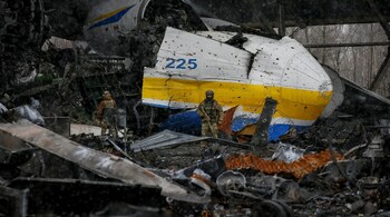 A Ukrainian service member walks in a front of the Antonov An-225 Mriya cargo plane, the world's biggest aircraft, destroyed by Russian troops as Russia's attack on Ukraine continues, at an airfield in the settlement of Hostomel, in Kyiv region, Ukraine April 3. (Image: Reuters)