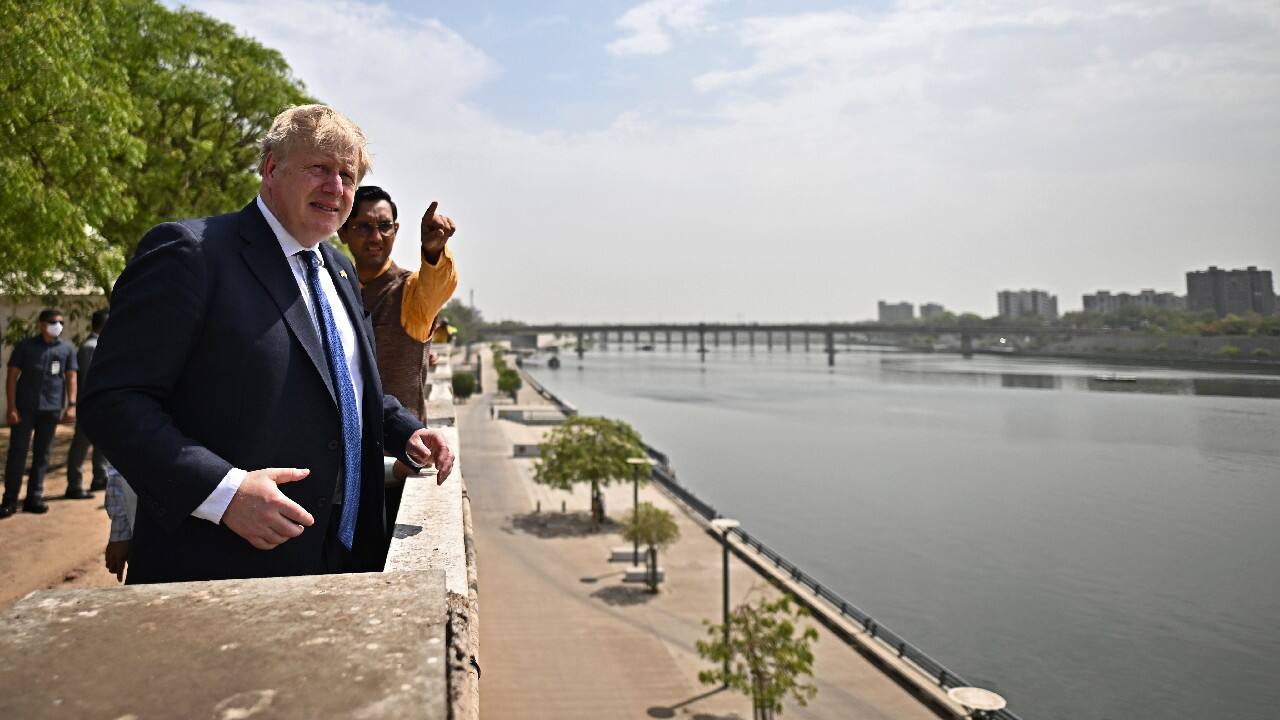 Johnson looks over the Sabarmati river during his visit at the Sabarmati Ashram. (Image: AP)