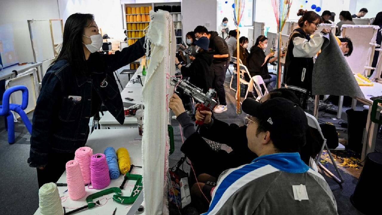 Chatter and laughter filled the room as they stopped to compare and admire each other's designs -- mostly cartoon character carpets or colourful patched handbags and mirrors. (Source: AFP) Chatter and laughter filled the room as they stopped to compare and admire each other's designs -- mostly cartoon character carpets or colourful patched handbags and mirrors. (Source: AFP)