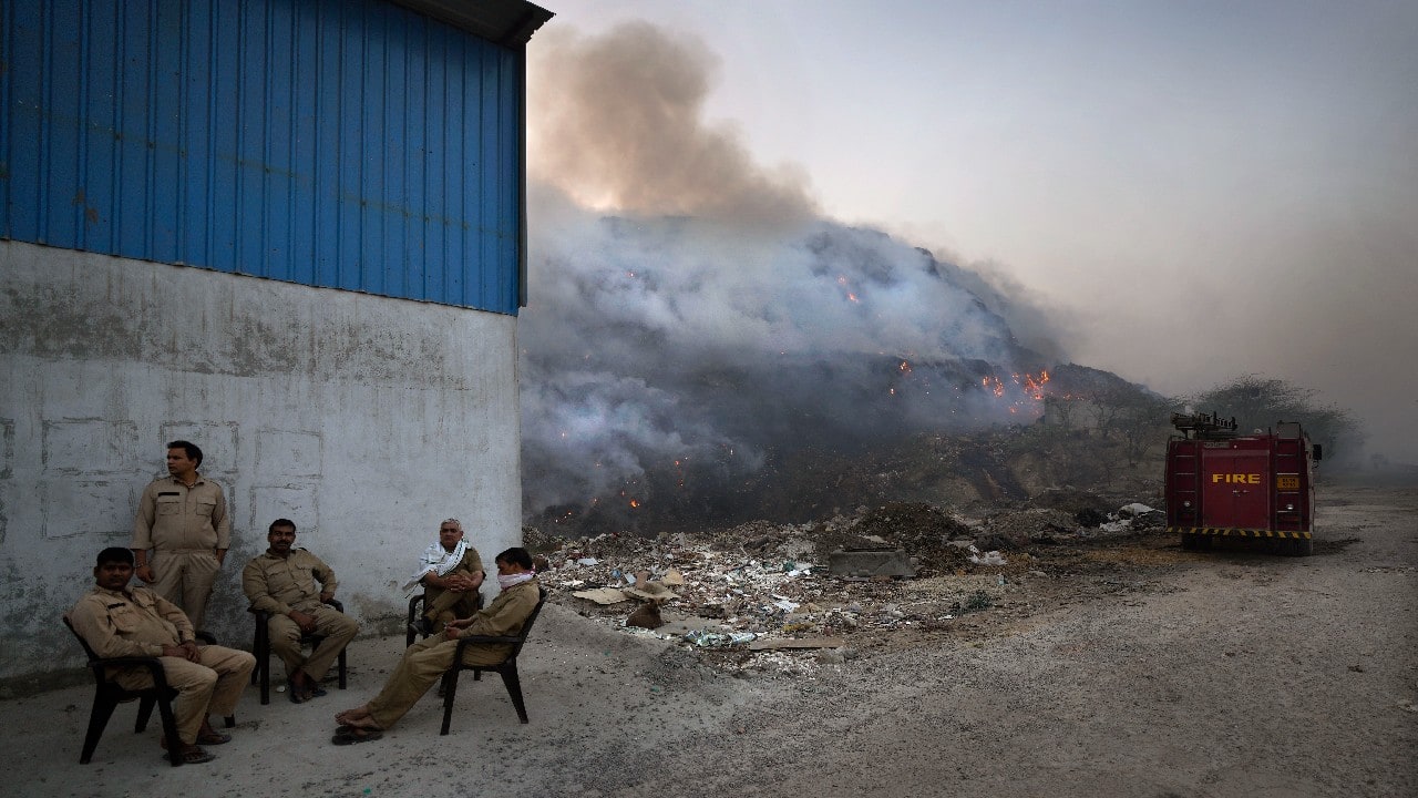 The landfill in northern Delhi’s Bhalswa is taller than a 17-story building and covers an area bigger than 50 football fields. Waste workers who live in nearby homes had emptied onto the streets in evening on April 26. (Image: AP)