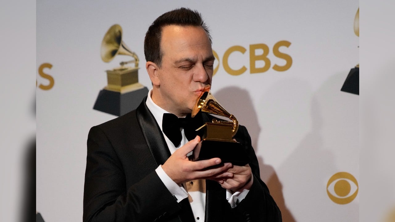 Carlos Rafael Rivera poses in the press room with the award for best score soundtrack for visual media for &quot;The Queen's Gambit&quot; at the 64th Annual Grammy Awards at the MGM Grand Garden Arena on April 3, in Las Vegas. (Image: AP)