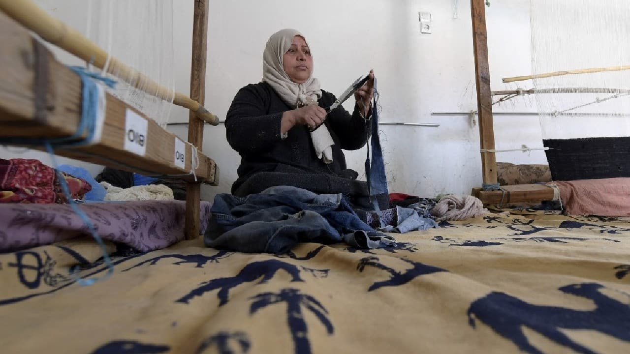 Najet unravels an old pair of jeans, raw material for a designer carpet: traditional, eco-friendly crafts are being adapted for new markets thanks to a project born in the Tunisian desert. "I learned to weave at a young age, from my mother," said the 52-year-old from the oasis town of Nefta, 500 kilometres (310 miles) south of Tunisia. (Image: AFP)