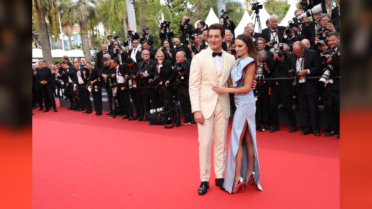 Miles Teller, left, and Keleigh Sperry pose for photographers upon arrival at the premiere of the film 'Top Gun: Maverick' at the 75th international film festival, Cannes, southern France, May 18. (Image: AP)