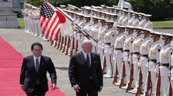 Fumio Kishida, Japan's prime minister, left, and US President Joe Biden review an honor guard during a welcome ceremony at the Akasaka Palace on Monday, May 23, 2022. Photographer: Eugene Hoshiko/AP Photo/Bloomberg