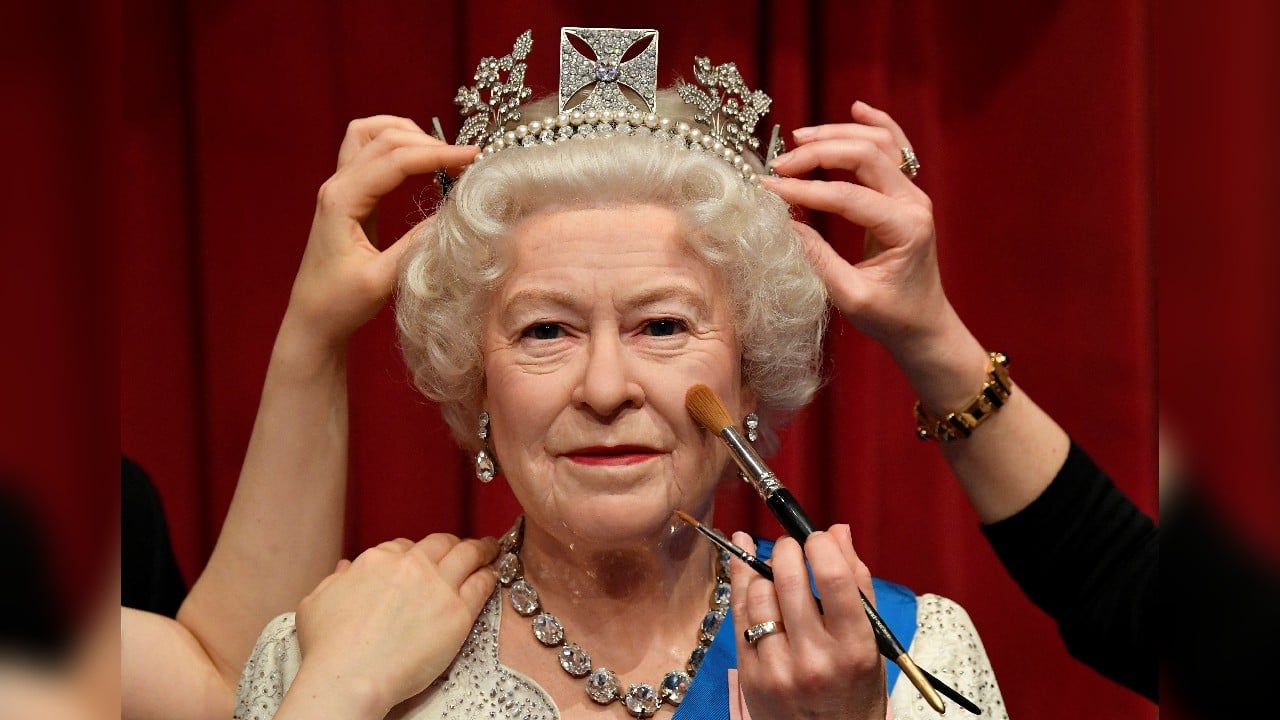 Studio artists retouch a wax work model of Queen Elizabeth as senior members of the British royal family go on display in a new grouping and outfits ahead of Platinum Jubilee celebrations, at Madame Tussauds in London, Britain, May 25. (Image: Reuters)