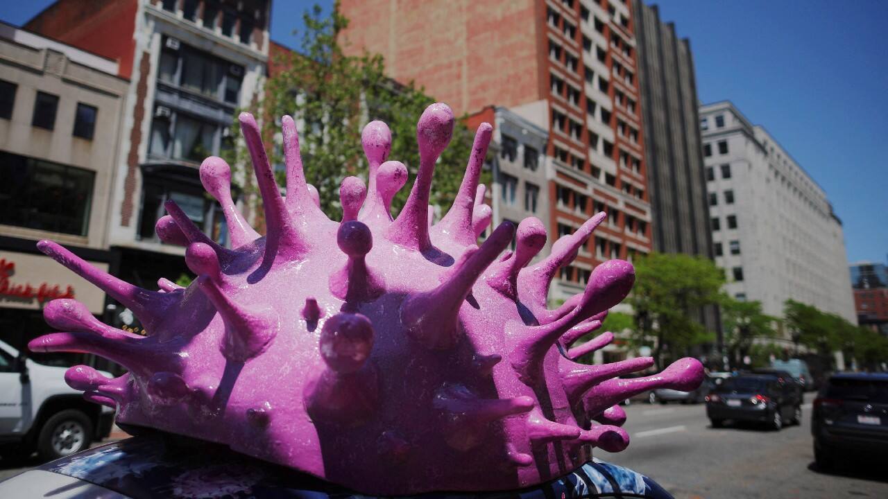 A model of a coronavirus virion sits on top of a car advertising home test kits for COVID-19 in Boston, Massachusetts, May 24. (Image: Reuters)