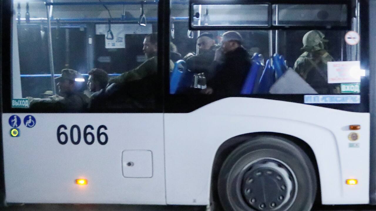 A bus carrying service members of Ukrainian forces from the besieged Azovstal steel mill drives away under escort of the pro-Russian military in the course of Ukraine-Russia conflict in Mariupol, Ukraine May 16. (Image: Reuters)