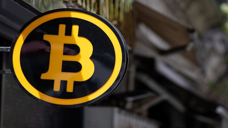 A Bitcoin logo sign outside a cryptocurrency exchange kiosk in Istanbul, Turkey, on Tuesday, April 26, 2022. Both tech stocks and Bitcoin have notched big swings this year as the Federal Reserve becomes less accommodative as part of its fight to combat inflation. Photographer: Erhan Demirtas/Bloomberg