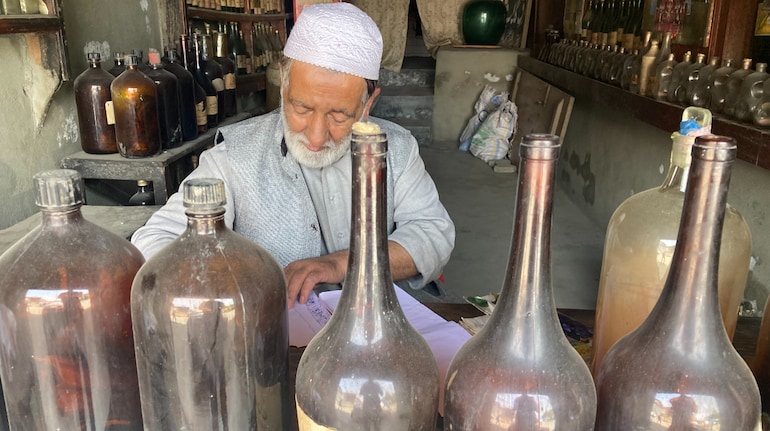 Abdul Aziz Kozgar, 66, at the 102-year-old Arq-I-Gulab Waan shop in downtown Srinagar. (Photo: Irfan Amin Malik)